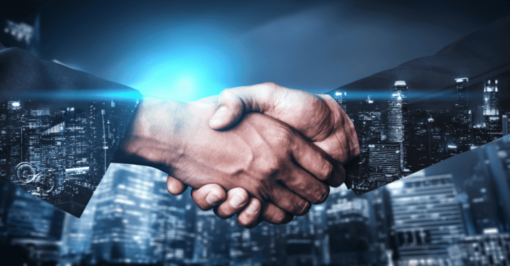 Partnership handshake between business professionals in a city skyline background, symbolizing technology collaboration, enterprise solutions, and innovative IT services by Banyan Technology.