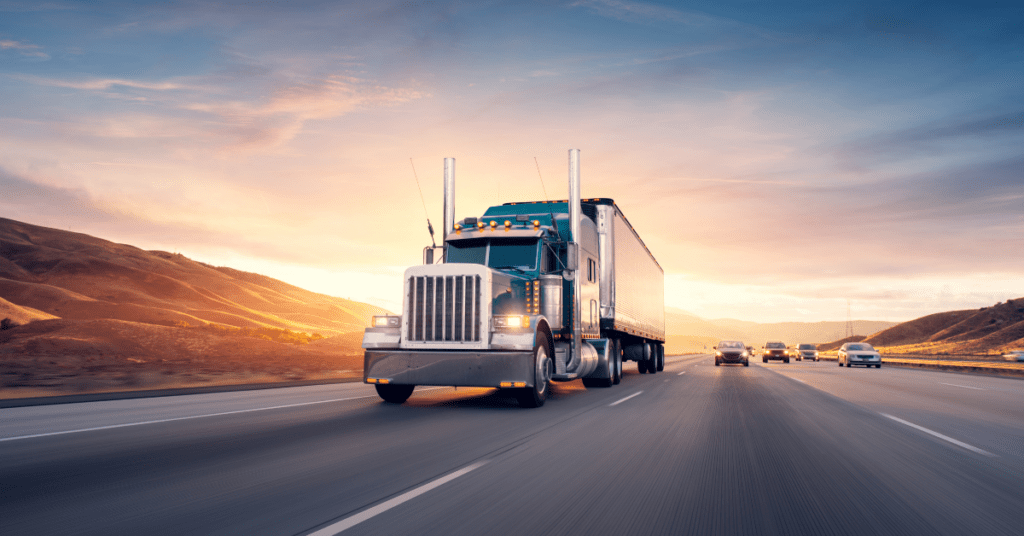 A freight truck driving on a highway with a shipment