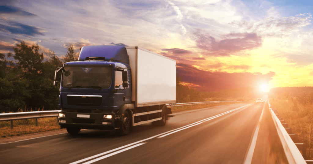 A local carrier box truck driving with a final mile delivery