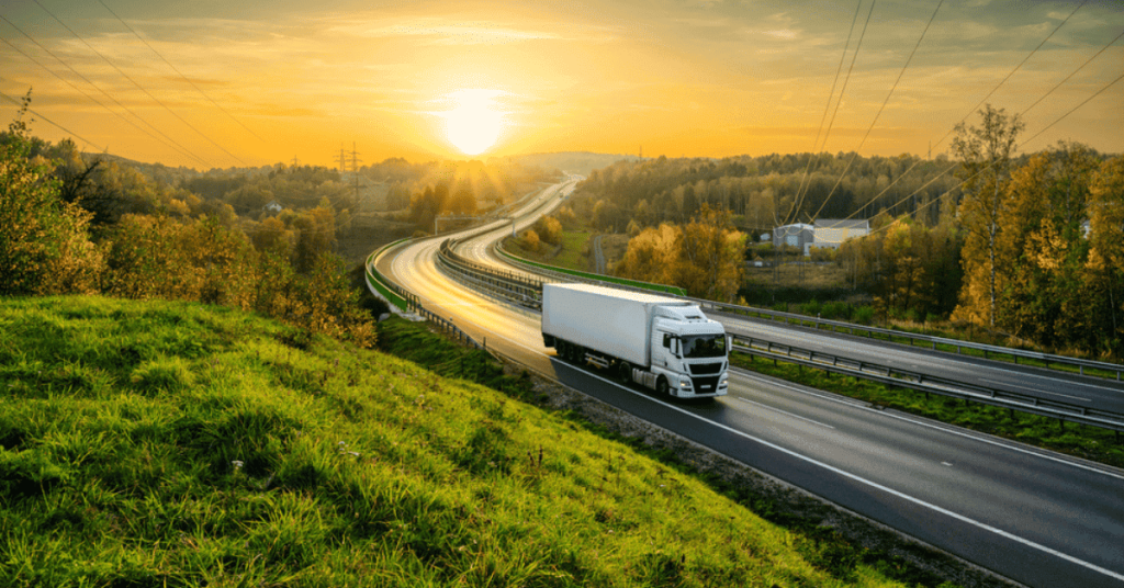 An OTR freight truck driving at sunset