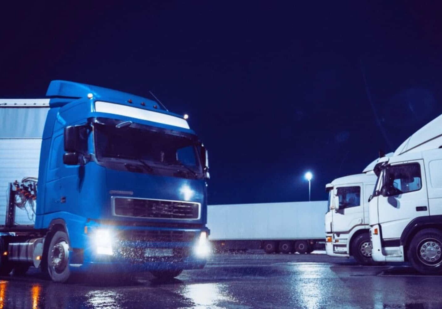 A freight truck entering a shipping facility at night